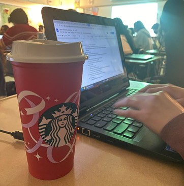 Lizzie Padva enjoying a cup of coffee in class.