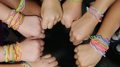 An image of children with Silly Bandz on their wrists