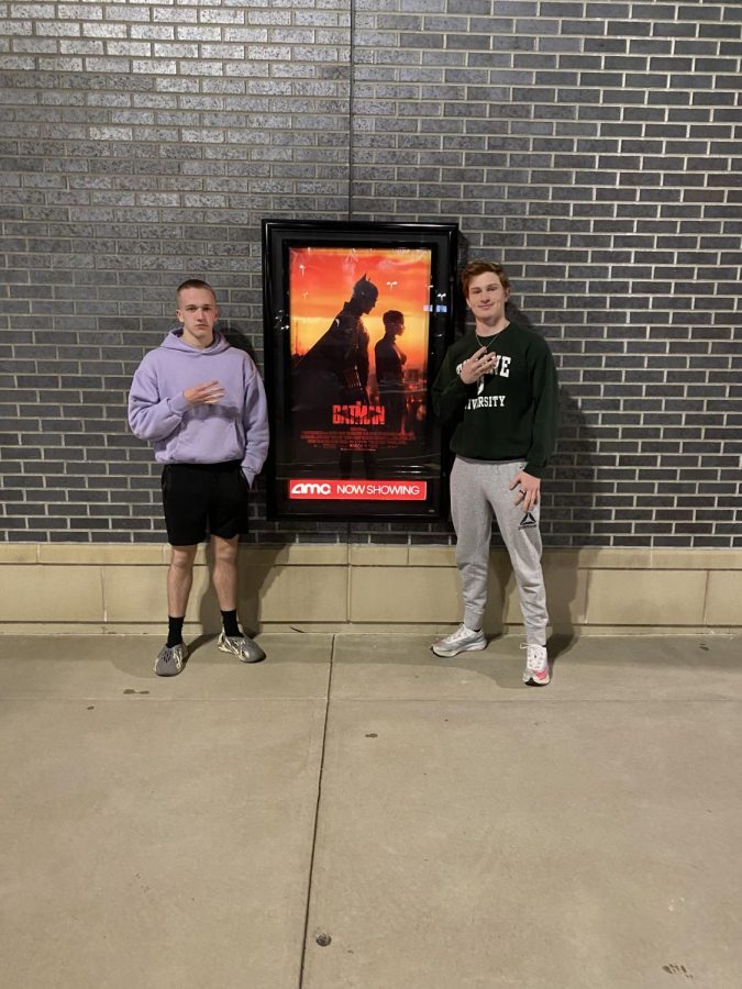 Chris Maguire and Gabe Daubert standing in front of the movie poster on opening night.