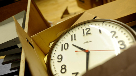 An iconic public school clock is packed away