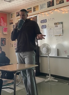 Mr. Edwards teaching class while sipping from his matching water bottle.