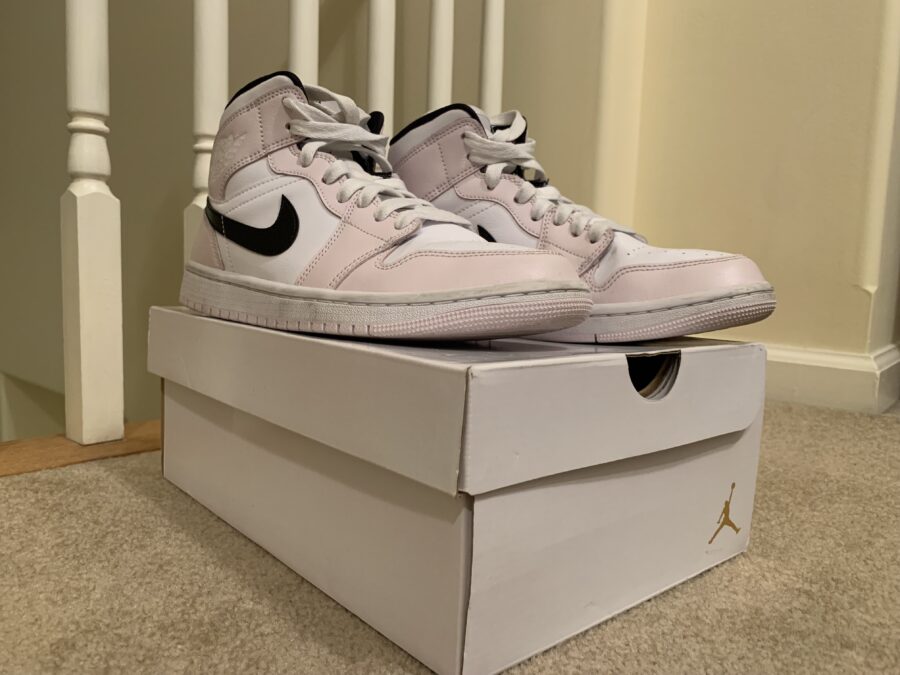 A worn pair of the Air Jordan 1 Barely Roses sits on display atop the Jumpman shoe box.