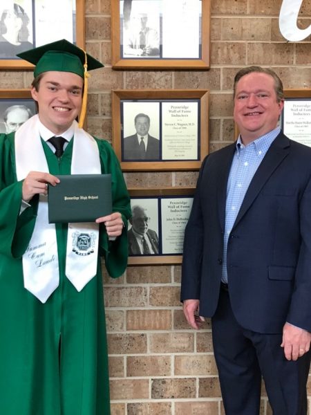 Dr. Steven Wagner and his son, Mitchell Wagner, standing next to his certificate on the Wall of Fame at Pennridge High School.