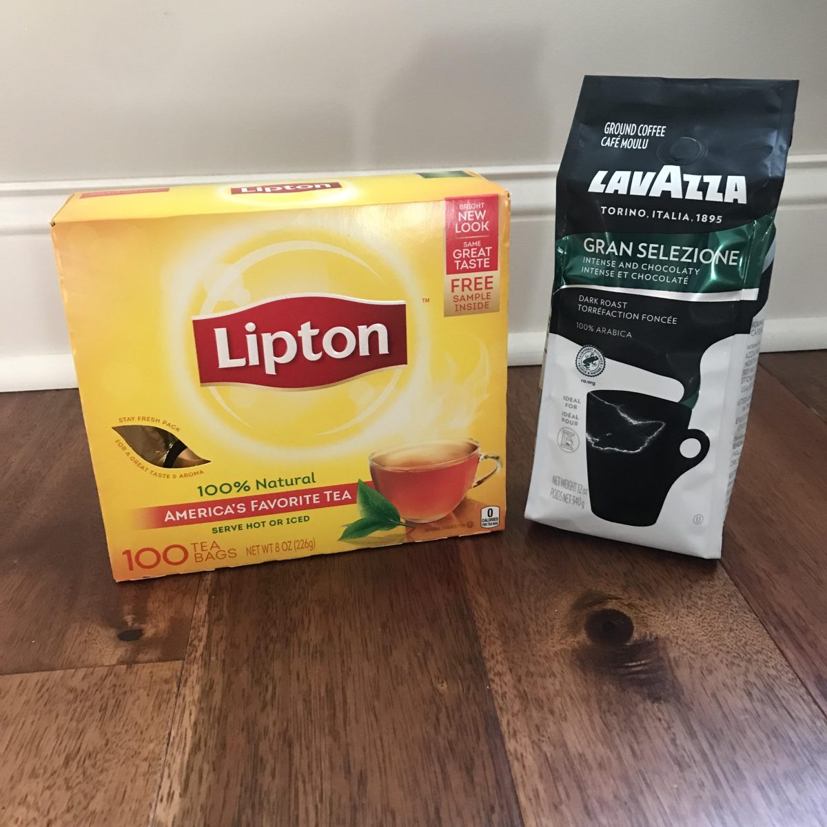 A box of Lipton tea next to a bag of Lavazza coffee.