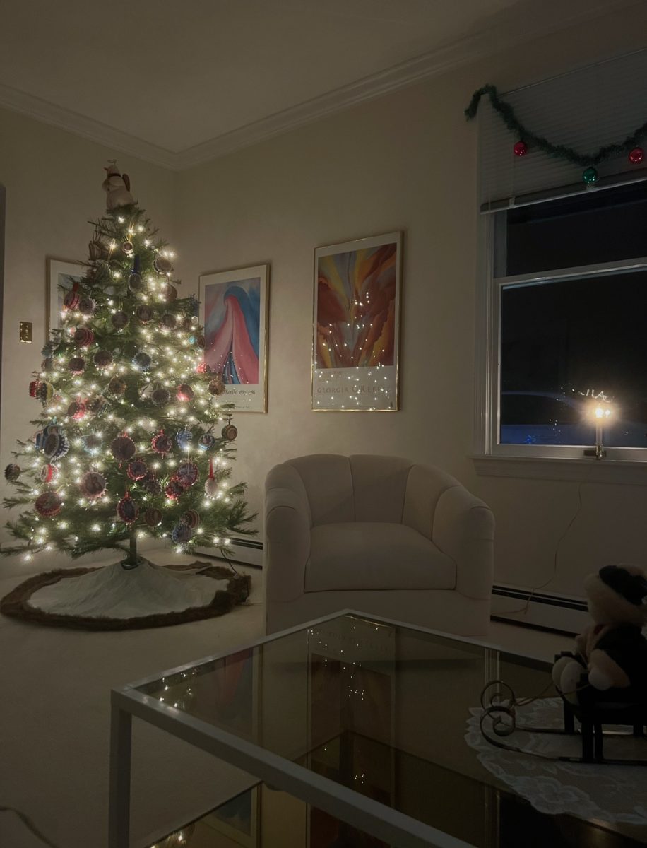 An+artificial+Christmas+tree+lit+on+a+winter+evening.