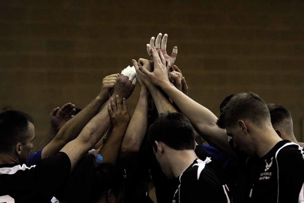 The Air Force Mens volleyball team puts their hands together