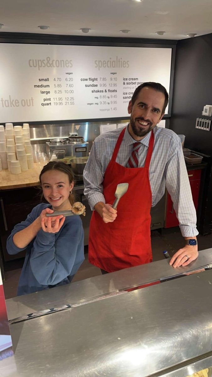 Student Erica Zysk and Principal Abram Hughes work a Dine and Donate at Owowcow. 