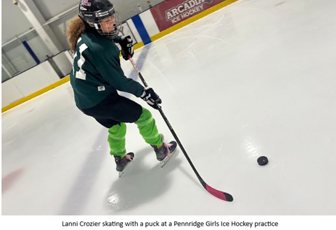 Lanni Crozier skating with a puck at Pennridge ice hockey practice