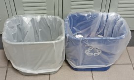 Image shows a regular trash and recycling can next to each other in one of the hallways at Pennridge High School.