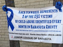 This Banner is trying to bring awareness to child abuse in Sarasota County. At the bottom there are phone numbers you can call.