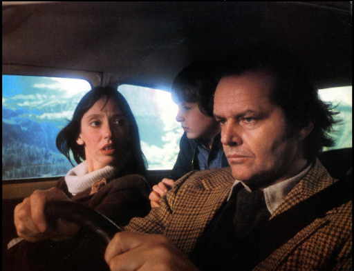 Picture from the film showing main cast Jack, Wendy, and Danny Torrence heading up to the Overlook.