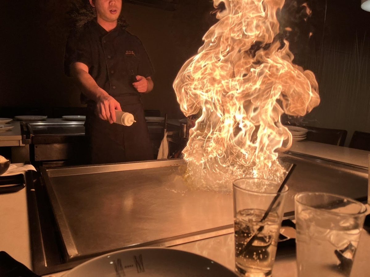 Hibachi chef at Ooka lights the grill in front of us. 