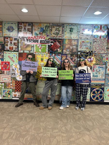 After escaping the room, the newsgroup had fun taking photos with fun props and signs