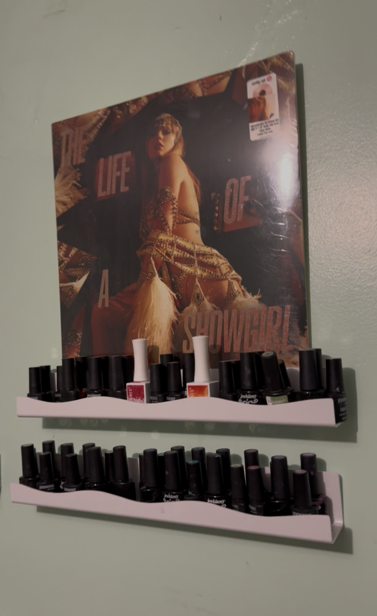 A Taylor Swift album vinyl on top of a nail supply shelf