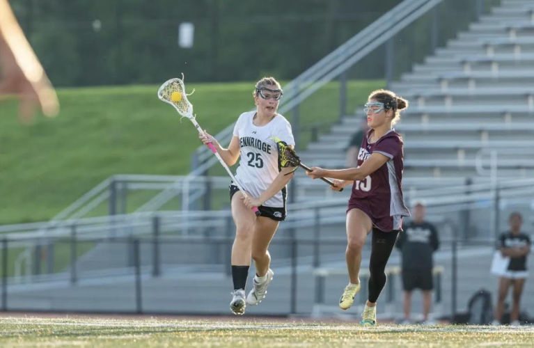 Norah Herbst carrying the ball in a game against Conestoga