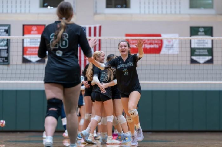 Chloe (#8) running to hug an injured teammate after she gets a point